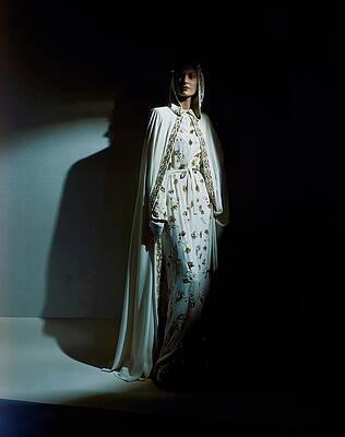 Elegant Woman in Embellished Cape Photograph