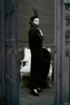 Wall Art featuring the photograph A Model Wearing An Adele Simpsons Ensemble by John Rawlings