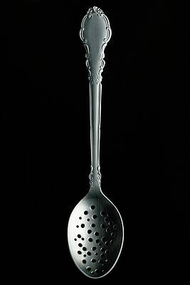 Silverware Wall Art featuring the photograph A Slotted Spoon by Romulo Yanes