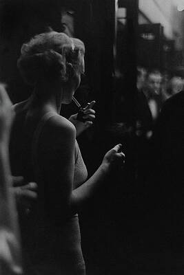 Lighting Wall Art featuring the photograph A Woman Smoking At The Music Box by Remie Lohse