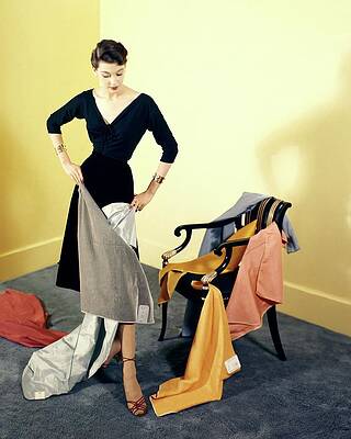 Wall Art featuring the photograph A Woman With Assorted Pieces Of Fabric by Herbert Matter