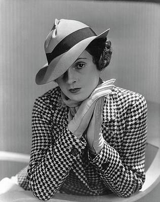 Wall Art featuring the photograph A Young Model Wearing A Tilted Hat With Her Hands by Lusha Nelson