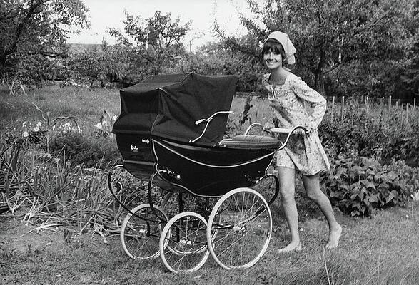 Smiling Woman with Vintage Baby Carriage Photograph