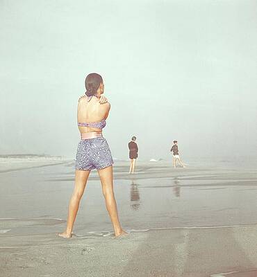 People Walking on a Misty Beach Photograph