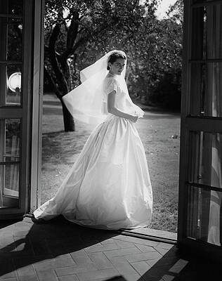 Bride Standing in Sunlit Doorway Photograph