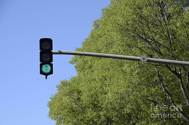 Green Traffic Light Against Blue Sky Wall Art