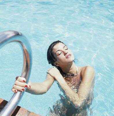 Woman Relaxing in a Swimming Pool Wall Art