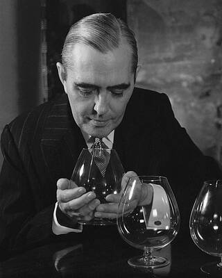 Wine Glass Wall Art featuring the photograph Julian Street Holding A Brandy Snifter by Eugene Hutchinson