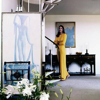 Woman in Yellow Near Spiral Staircase Photograph