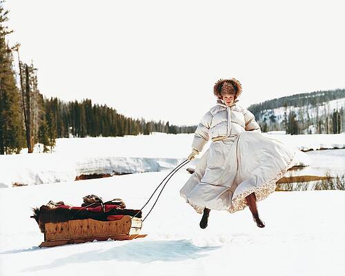Woman Jumping Playfully in Snow Photograph