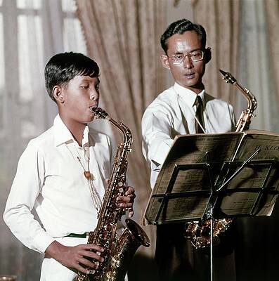 Thailand Wall Art featuring the photograph King Bhumibol And Prince Vajirlongkorn Playing by Henry Clarke