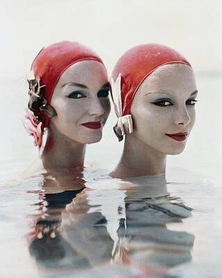 Elegant Swimmers with Red Caps Photograph