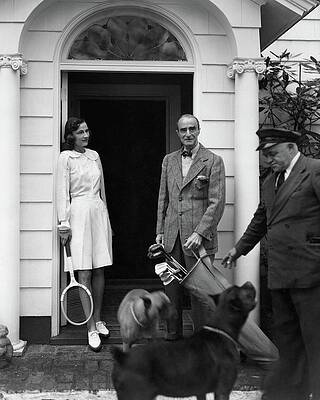 Elegant Couple with Tennis Gear Photograph