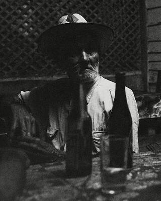 Man Seated with Bottles in Shadow Wall Art