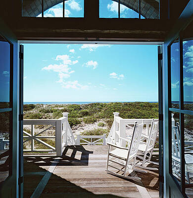 Coastal Retreat with White Rocking Chairs Photograph