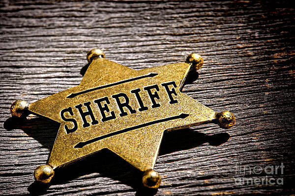 Sheriff Badge on Wooden Background Photograph