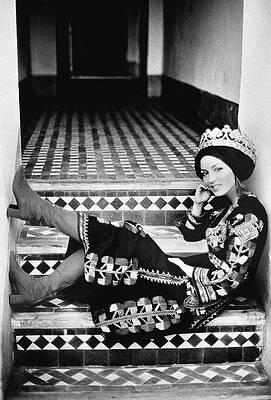 Woman in Traditional Attire on Steps Photograph