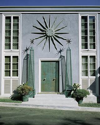Mid-Century Modern Facade with Sun Motif Wall Art