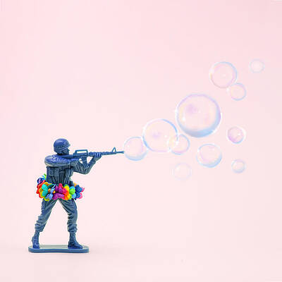 Wall Art featuring the photograph Toy Soldier Shooting Bubbles From Gun by Juj Winn