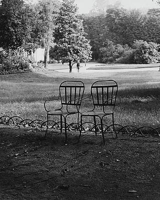 Empty Chairs in a Sunlit Park Photograph