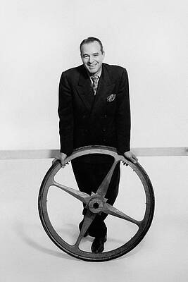 Wall Art featuring the photograph William Pahlmann Holding A Wheel by Herbert Matter