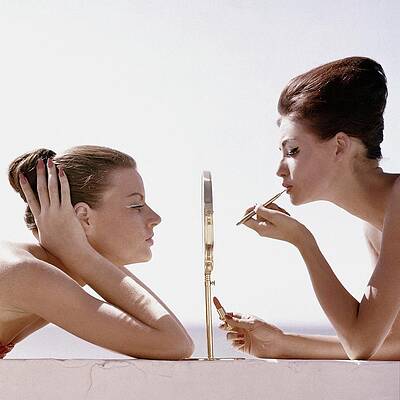 Two Women Applying Makeup Photograph