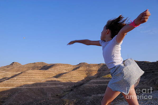 Landscape Photograph - Girl Throwing Stone In Sky by Sami Sarkis Photography