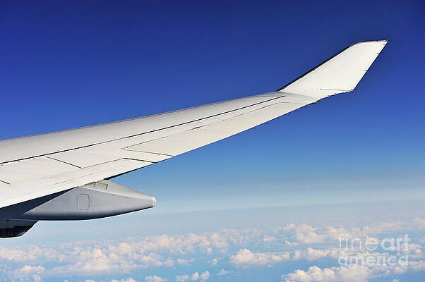 Transportation Wall Art featuring the photograph Wing Of Flying Airplane Above Clouds by Sami Sarkis Photography