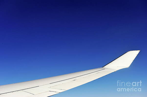 Transportation Wall Art featuring the photograph Wing Of Flying Airplane On Clear Blue Sky by Sami Sarkis Photography