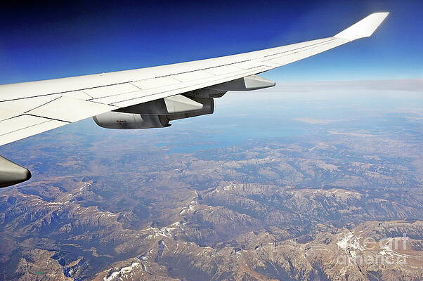 Transportation Wall Art featuring the photograph Wing Of Flying Airplane Over Wyoming Mountains by Sami Sarkis Photography