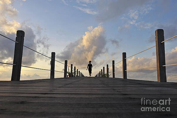 Cloud Photograph - Woman Running On Wooden Jetty At Sunrise by Sami Sarkis Photography
