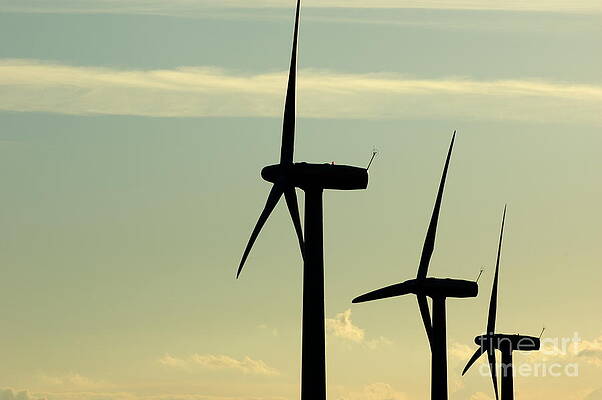 Cloud Photograph - Silhouetted Wind Turbines Against A Cloudy Sky #1 by Sami Sarkis Photography