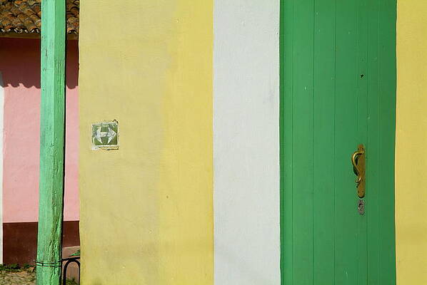 City Photograph - Arrow Sign On A Building Next To A Green Door On A Street In Trinidad by Sami Sarkis Photography