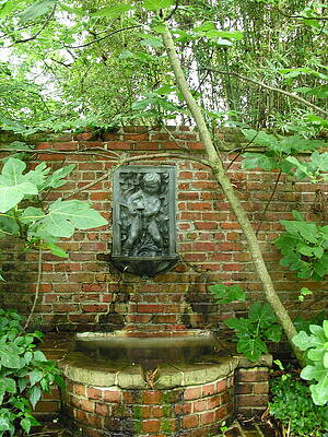 Garden Wall Art featuring the photograph Fountain On A Red Brick Wall by C Thomas Cooney