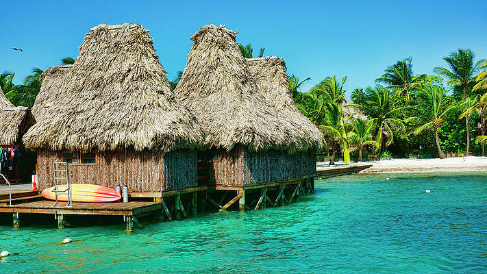 Wall Art featuring the photograph Grass Huts On The Water Of Ambergris Caye Belize by Waterdancer