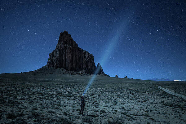 Sky Photograph - Hiker With A Head Lamp Under The Night Sky Near Shiprock, New Mexico by Miroslav Liska