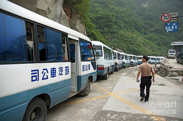 Wall Art featuring the photograph Man Searching Among A Row Of Tourist Buses Parked On Mount Hua by Sami Sarkis Photography