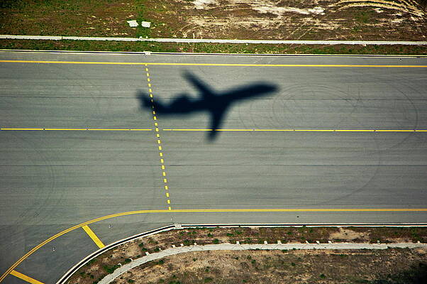 Transportation Wall Art featuring the photograph Shadow Of An Airplane Taking Off by Sami Sarkis Photography