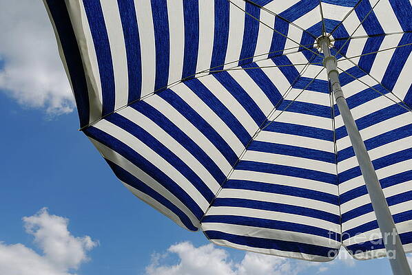 Outdoors Wall Art featuring the photograph Striped Beach Umbrella Against Blue Sky by Sami Sarkis Photography