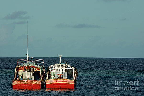 Transportation Wall Art featuring the photograph Two Red Fishing Boats Moored Side By Side In The Blue Ocean by Sami Sarkis Photography