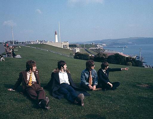 Band Relaxing on Coastal Lawn Photograph