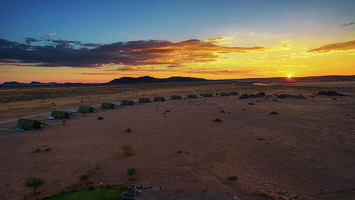 Sunrise Wall Art featuring the photograph Sunset Above Small Chalets Of A Desert Lodge Near Sossusvlei In Namibia #1 by Miroslav Liska