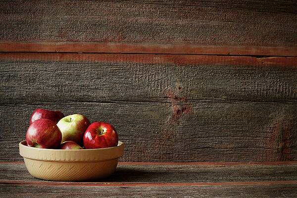 A Bowl Of Assorted Apples In A Rustic Setting Print