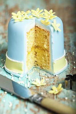 A Layer Cake Iced With Blue Fondant And Decorated With Marzipan Flowers, Cut Open To Show The Centre Print