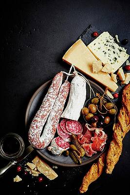 A Mixed Antipasti Platter With Olives, Capers, Prosciutto, Dried Sausage, Salami, Grissini, Parmesan And Blue Cheese Print