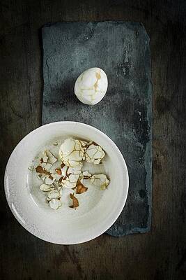 A Peeled Pickled Egg With A Linen Patter On A Slate Surface With Egg Shell In A Ceramic Bowl On A Wooden Surface Print