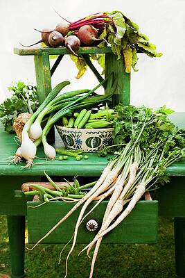 A Still Life Featuring Assorted Fresh Vegetables From The Garden On An Old Green Table, With An Open Drawer, An Old Ceramic Bowl And A Wooden-handled Knife Print