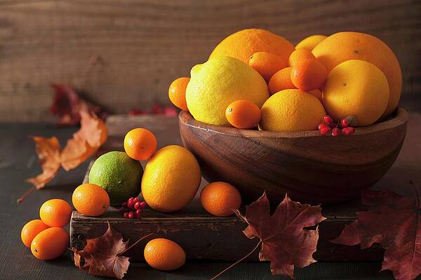 A Still Life Featuring Citrus Fruits And Autumn Leaves Print