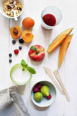 A Still Life Of Cereals, Fruits, A Glass Of Milk And Fruit Juice Print