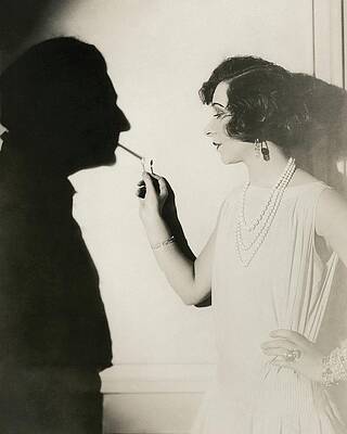 Wall Art featuring the photograph Yvonne Printemps Lighting A Shadow's Cigarette by Florence Vandamm